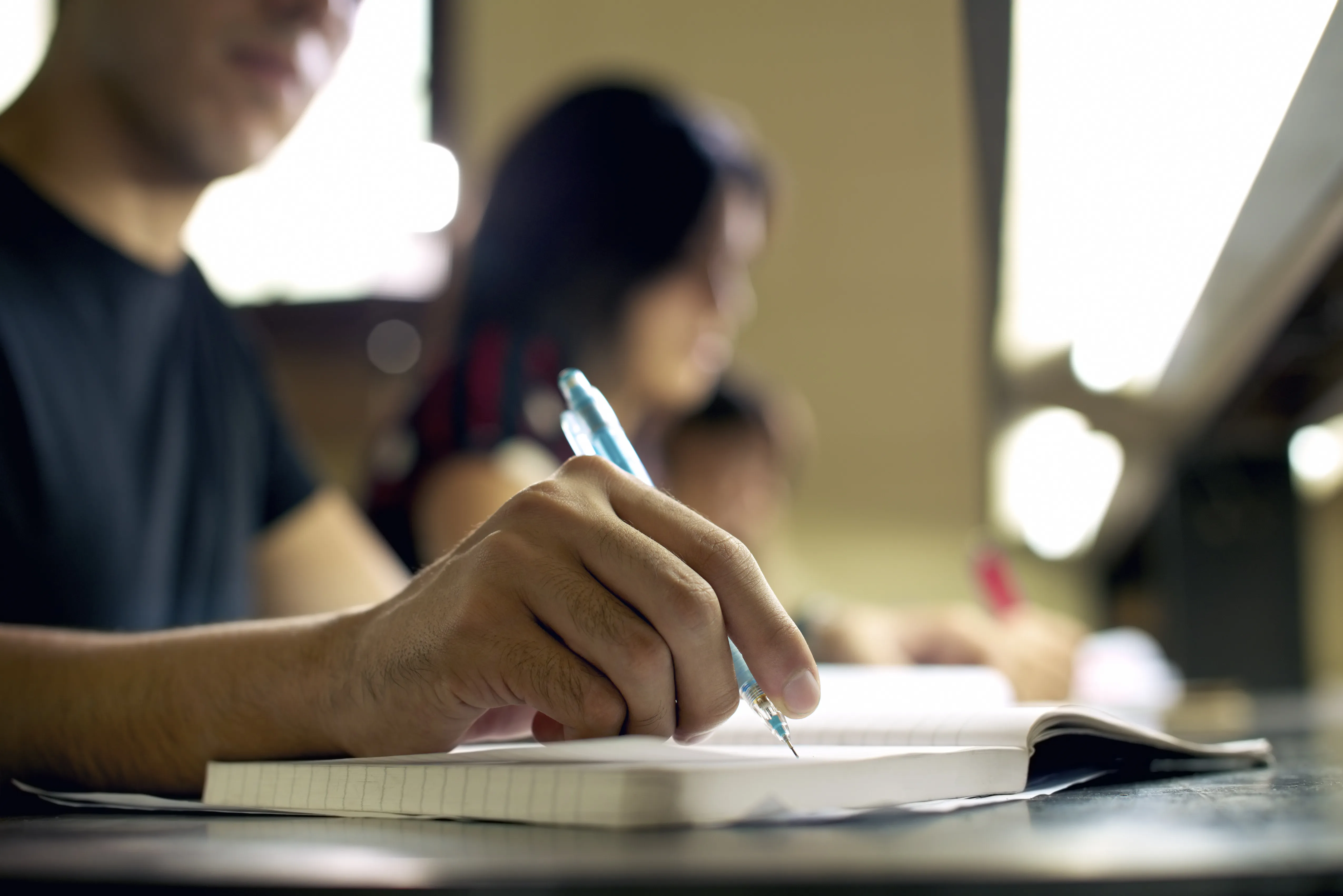 Man writing into notebook